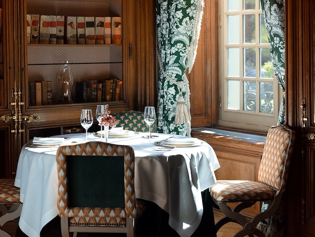 Various dishes served on a table next to a window